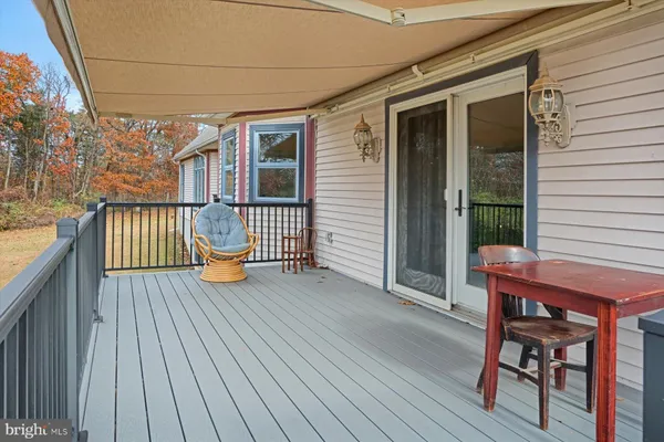 a view of porch with wooden floor