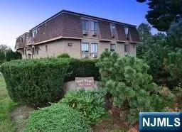 a view of a house with a yard and potted plants