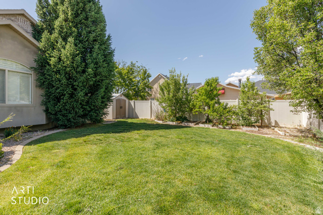 2327 Bluff Ridge Drive Syracuse, UT 84075 - Photo 51 of 66 Spacious lawn bordered by a paved walkway and mature trees