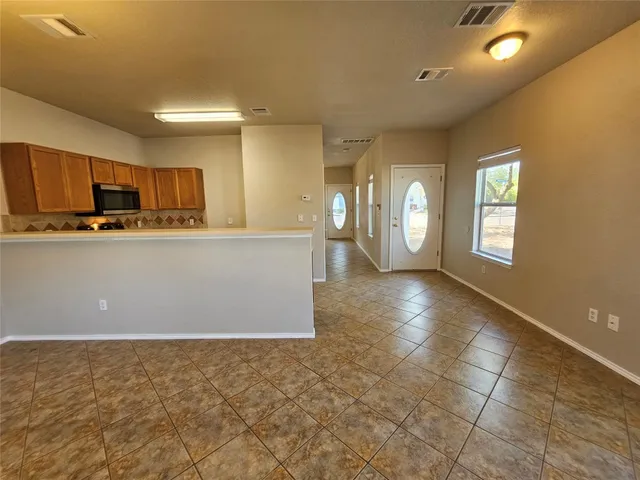 a view of a kitchen with kitchen island wooden floor and window