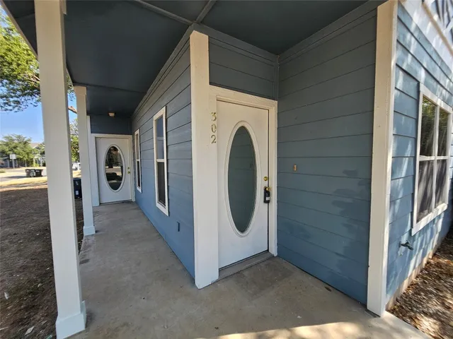 a view of a hallway with washer and dryer