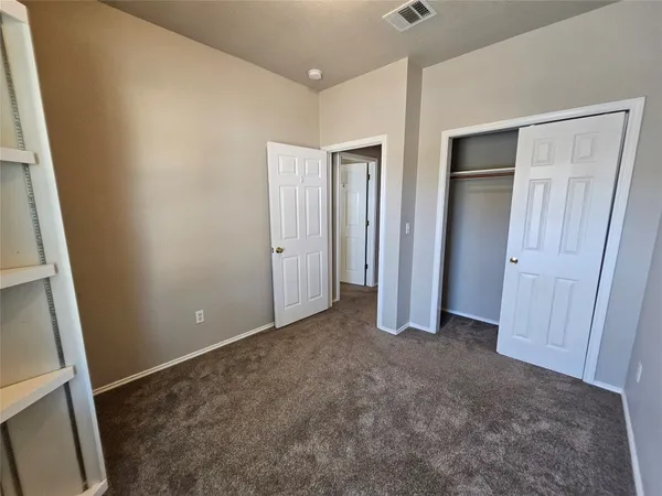 a view of an empty room with a fireplace