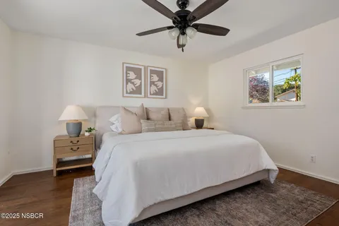 a bedroom with bed and a large mirror