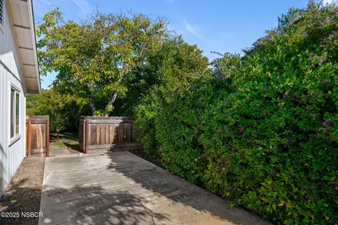 a view of backyard with swimming pool and green space
