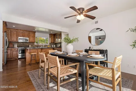 a kitchen with stainless steel appliances granite countertop a stove top oven a sink and white cabinets