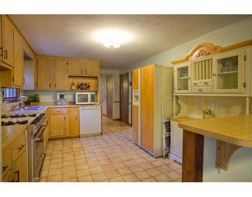 118 Crooked Spring Road Chelmsford, MA 01863 - Photo 12 of 13 a kitchen with stainless steel appliances kitchen island granite countertop a refrigerator a stove top oven and a sink