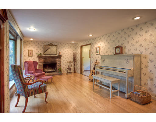 118 Crooked Spring Road Chelmsford, MA 01863 - Photo 4 of 13 a living room with furniture a fireplace and a flat screen tv