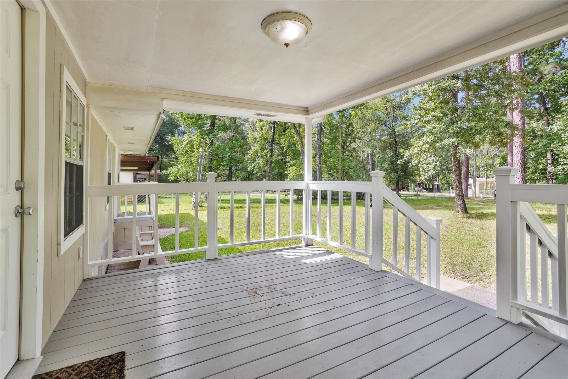 99 Main Street Huntsville, TX 77340 - Photo 6 of 47 Covered wood porch with white railings give this home great curb appeal.