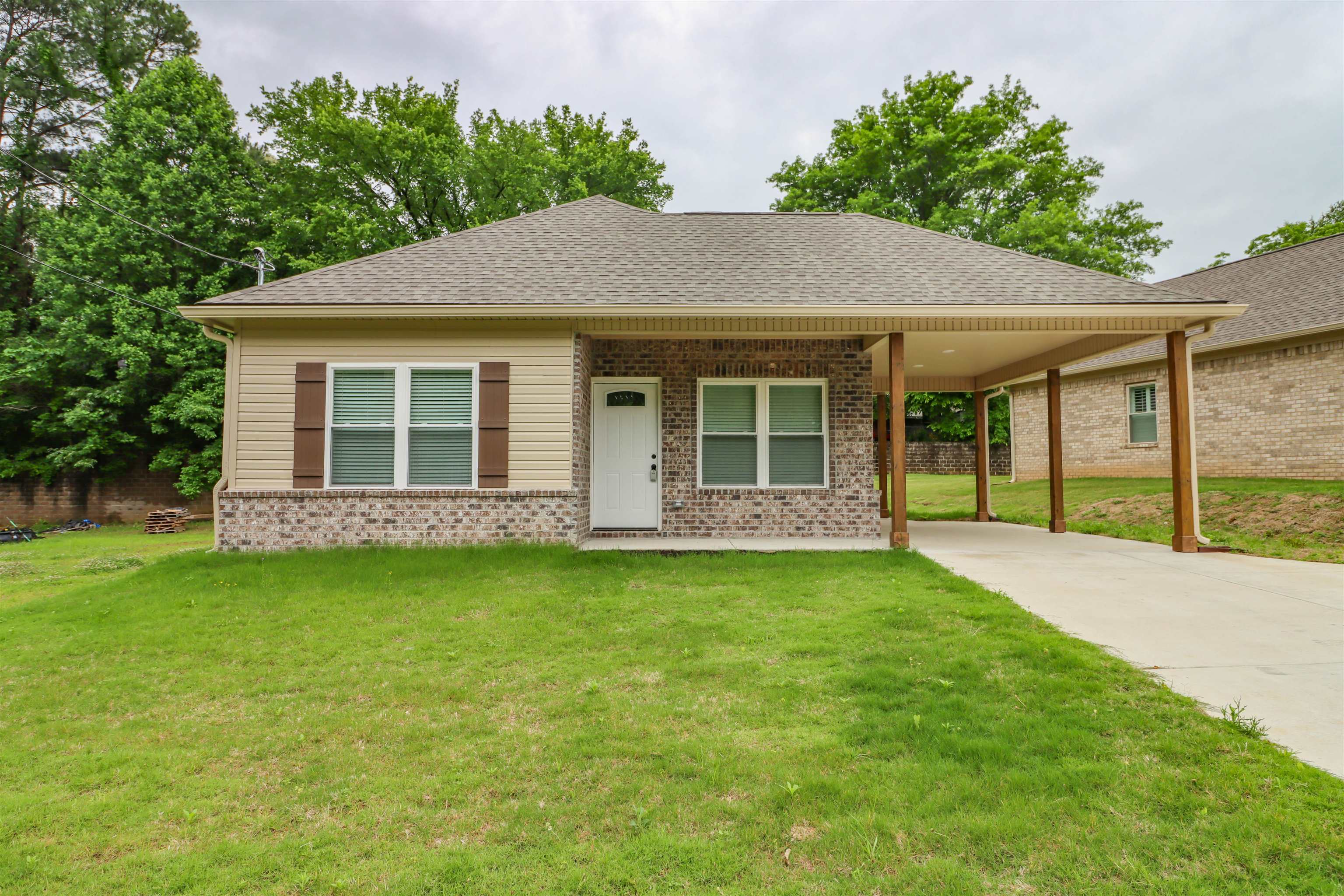 208 Church Street Ripley, TN 38063 - Photo 1 of 33 View of front of home featuring concrete driveway, brick siding, and a front lawn