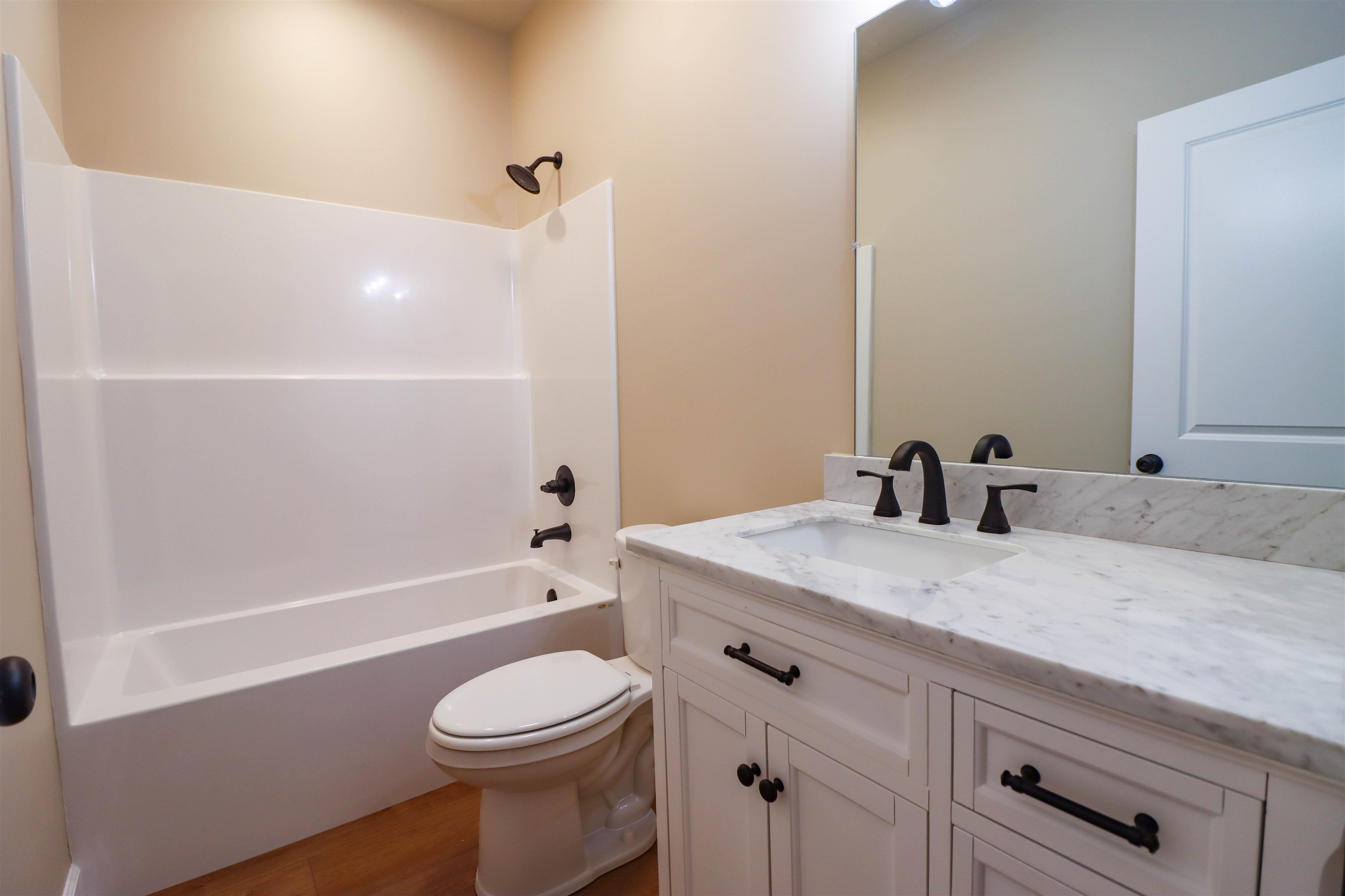 208 Church Street Ripley, TN 38063 - Photo 29 of 33 Bathroom 2 with toilet, vanity, luxury vinyl floors, and shower / tub combination