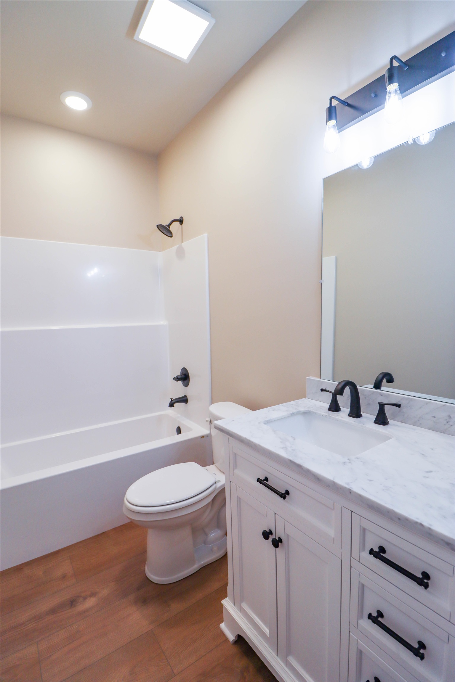 208 Church Street Ripley, TN 38063 - Photo 30 of 33 Bathroom 2 with toilet, vanity, luxury vinyl floors, and shower / tub combination