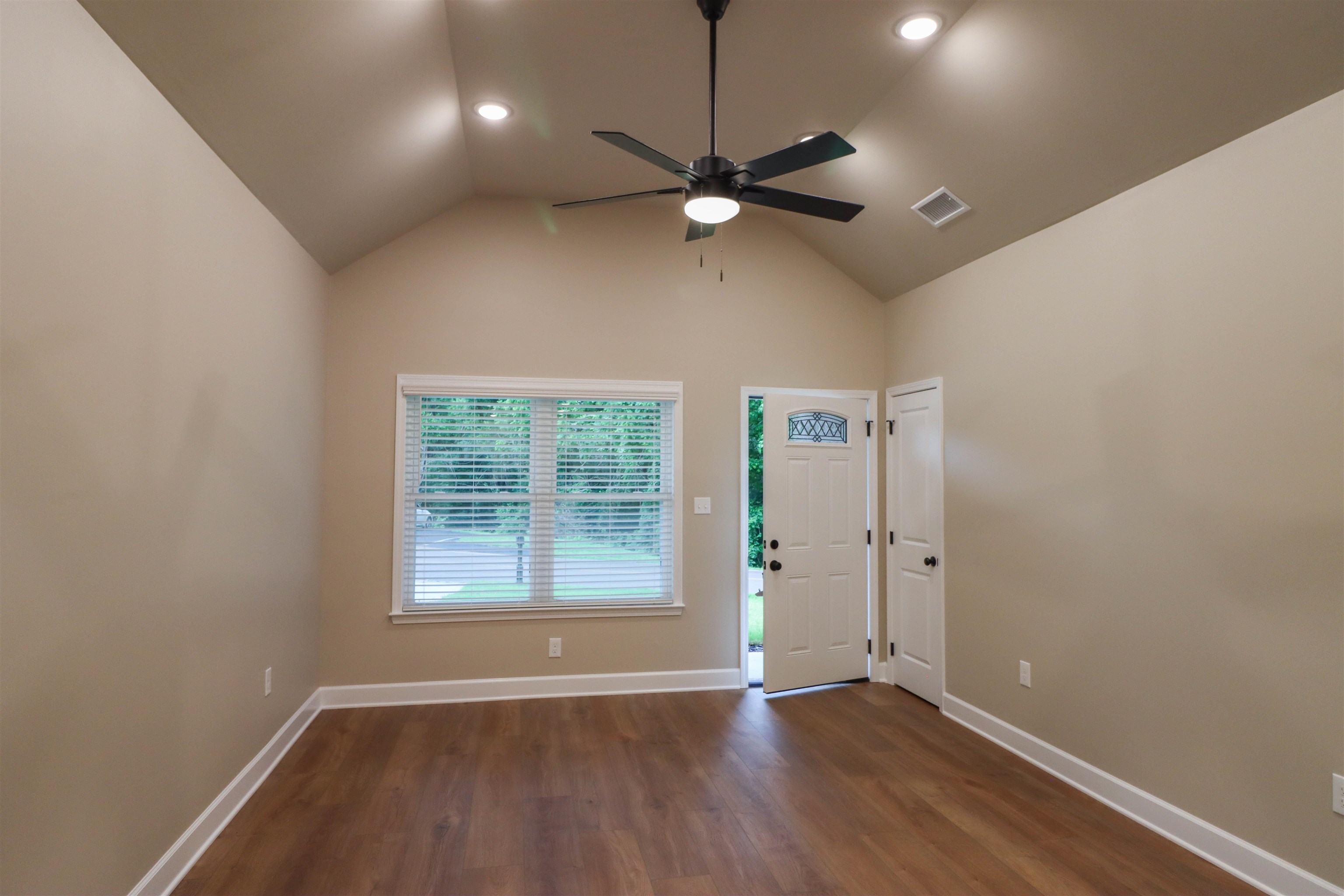 208 Church Street Ripley, TN 38063 - Photo 5 of 33 Great Room featuring a ceiling fan, dark wood-style flooring, high vaulted ceiling.