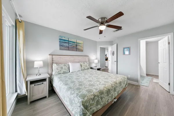 a bedroom with a bed and a chandelier