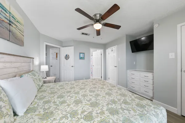 a bedroom with a bed and a television
