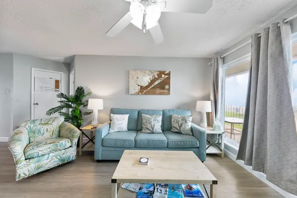 a living room with furniture and a chandelier