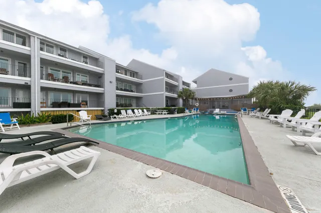 a aerial view of a house with swimming pool and a yard