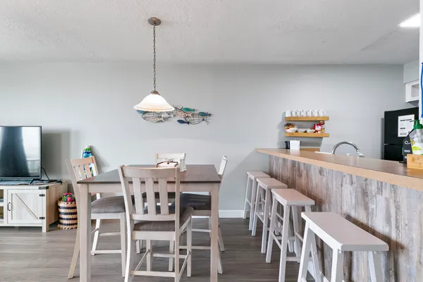 a view of a dining room with furniture wooden floor and chandelier
