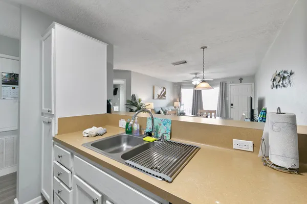 a room with a table chairs and a refrigerator