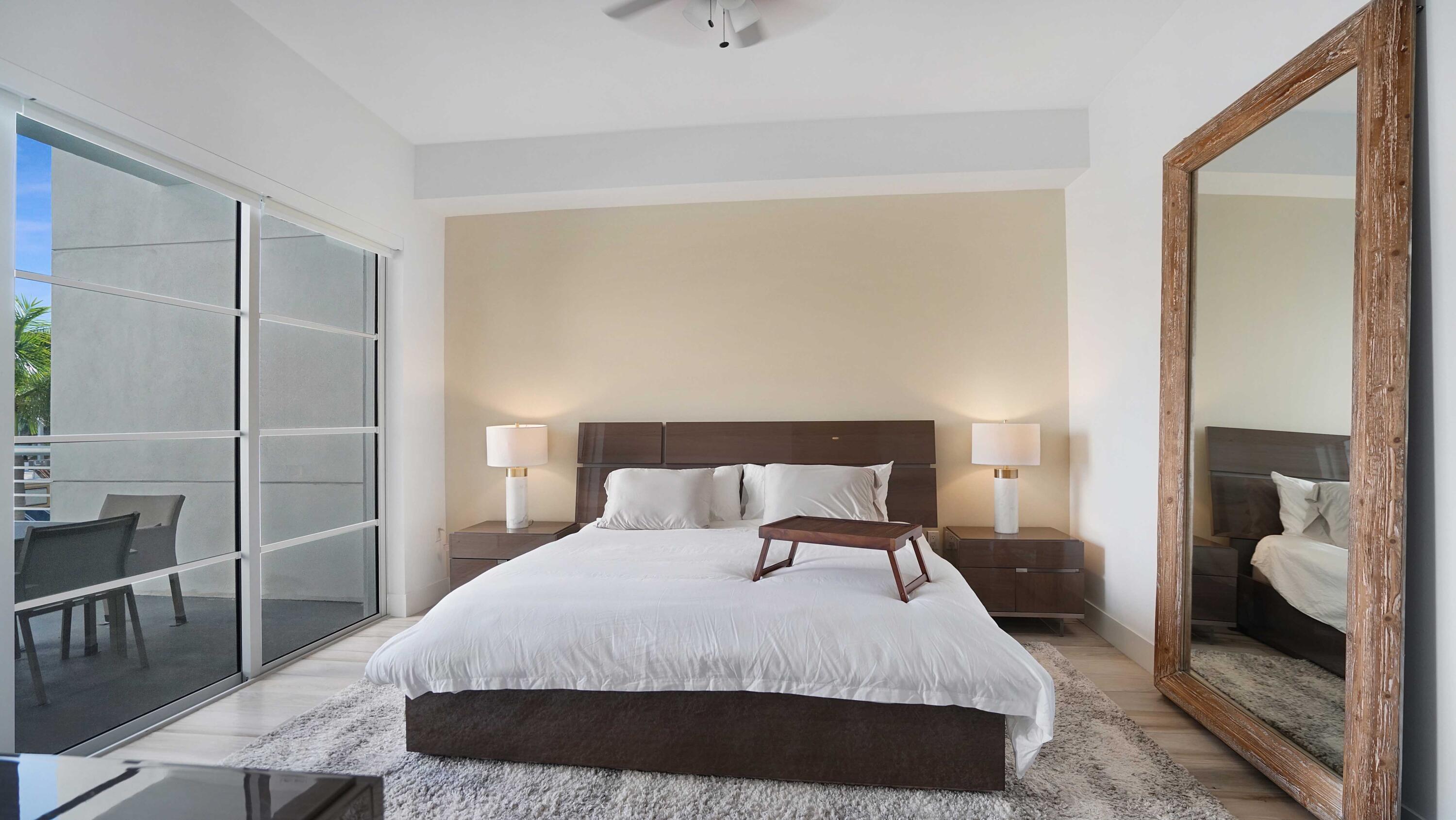 155 East Boca Raton Road, Unit 301 Boca Raton, FL 33432 - Photo 19 of 60 a bedroom with a bed and walk in closet