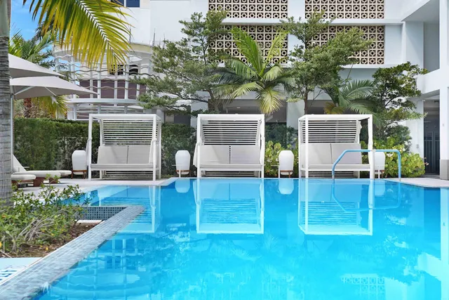 a view of a patio with couches under an umbrella