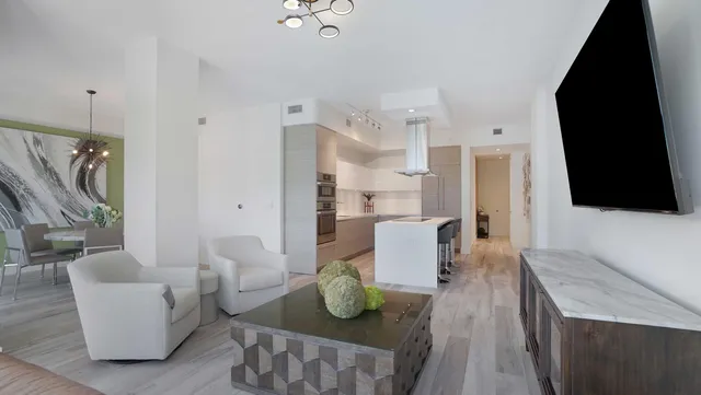 a kitchen with stainless steel appliances granite countertop a sink and a refrigerator