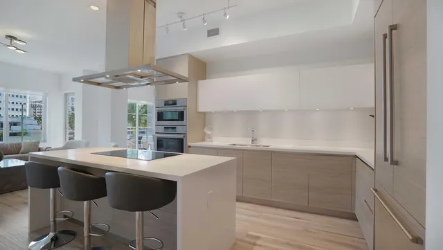 a kitchen with stainless steel appliances a sink a stove and a refrigerator