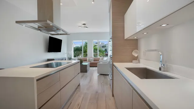 a kitchen with granite countertop a sink and stainless steel appliances