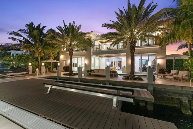 a aerial view of a house with swimming pool lawn chairs and a yard