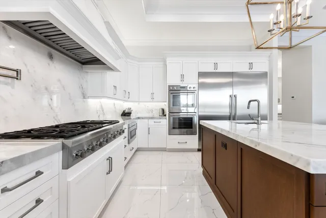 a view of a hallway with wooden floor and a bathroom