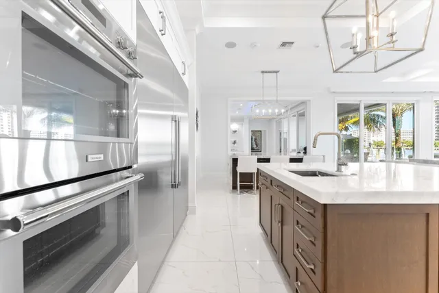a view of a walk in closet with clothes and shoes