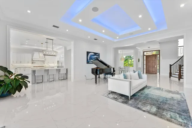 an aerial view of residential houses with outdoor space and lake view