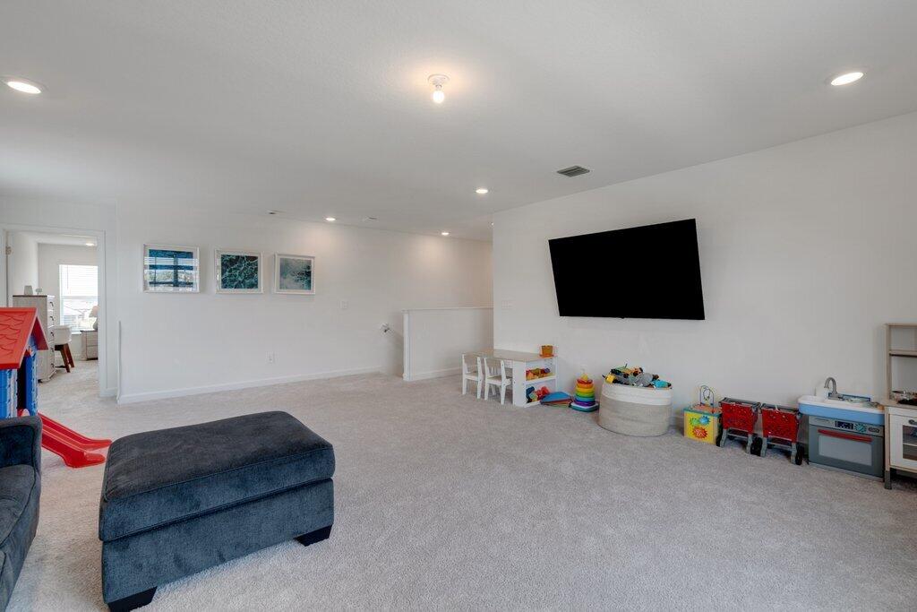 12328 Southwest Roma Circle Port St. Lucie, FL 34987 - Photo 31 of 72 2nd Story Family Room to Stairs.jpg-SMAL