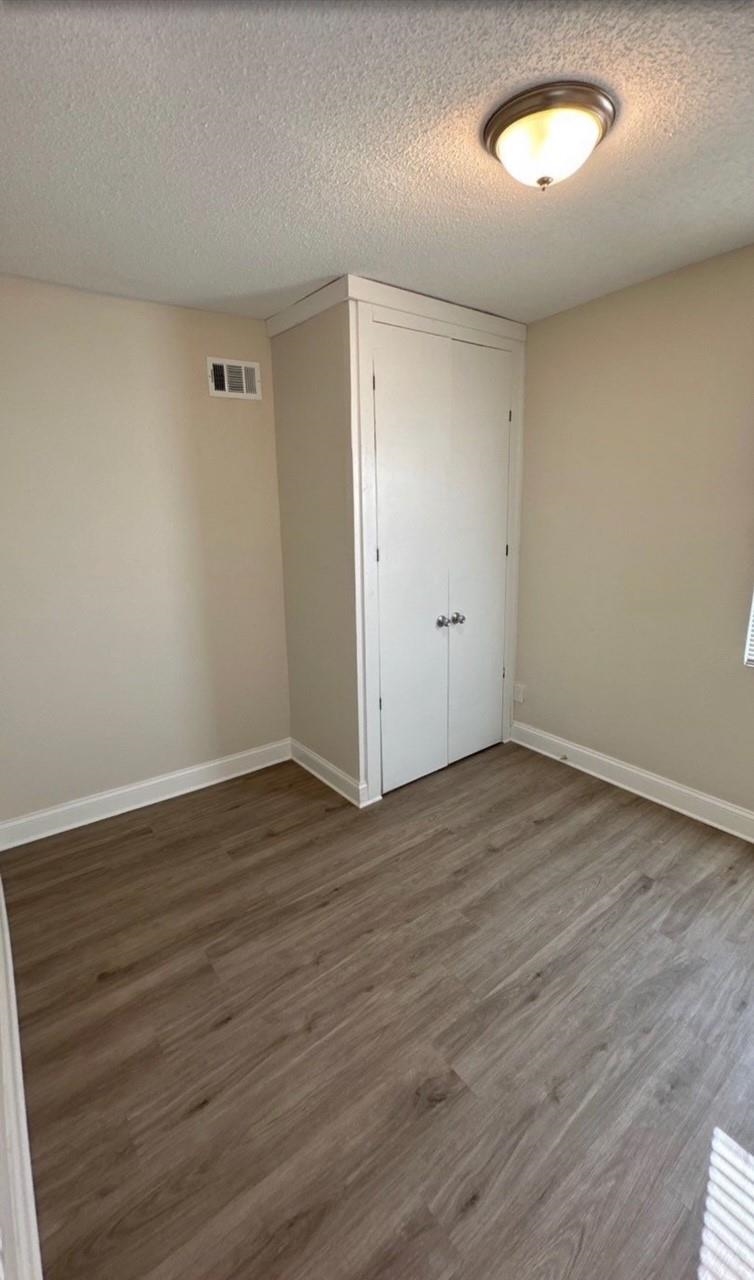 3333 Farmville Road Memphis, TN 38122 - Photo 2 of 12 an empty room with wooden floor and windows