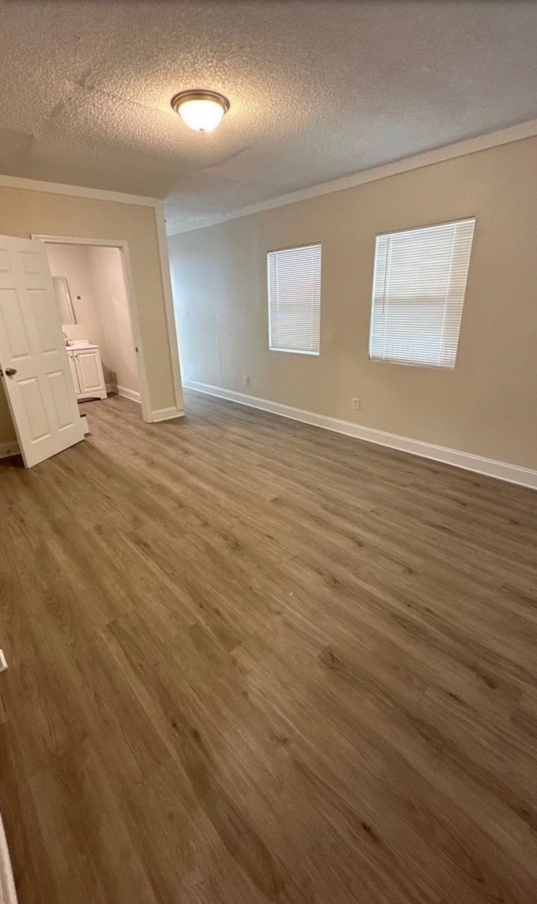 3333 Farmville Road Memphis, TN 38122 - Photo 5 of 12 an empty room with wooden floor and windows