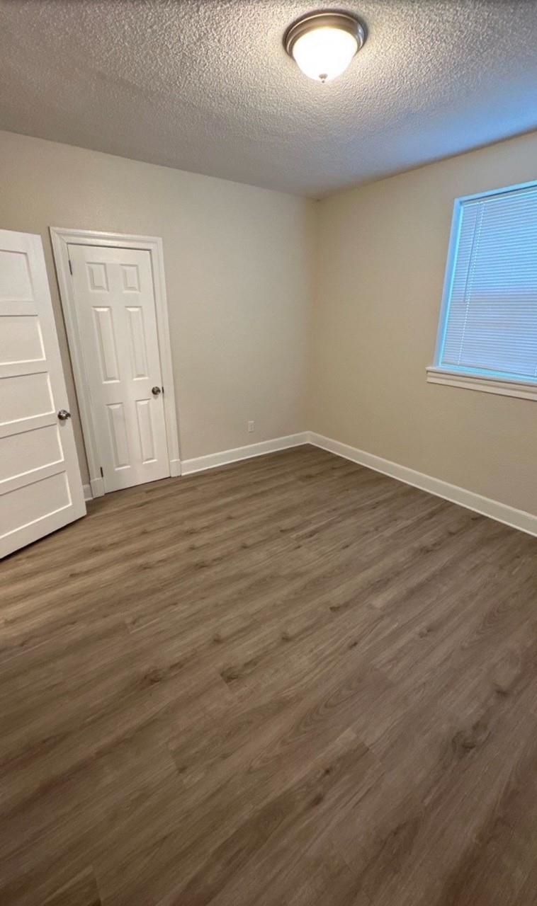 3333 Farmville Road Memphis, TN 38122 - Photo 9 of 12 a view of an empty room with wooden floor and a window