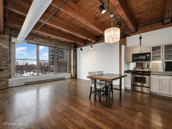 a view of a dining room with furniture wooden floor and a chandelier