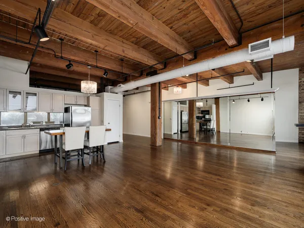 a dining room with furniture wooden floor a table and chairs