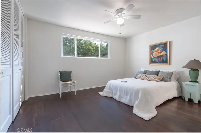 a spacious bedroom with a bed and a window