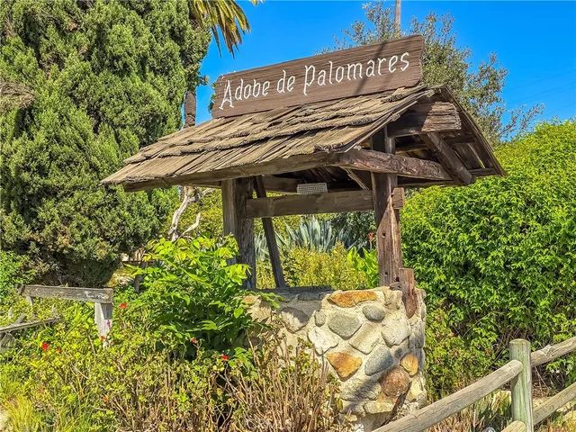 a view of a patio with table and chairs under an umbrella
