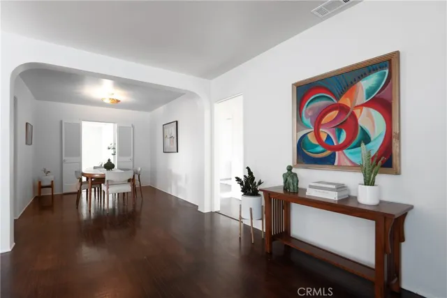 a view of a room with furniture and wooden floor