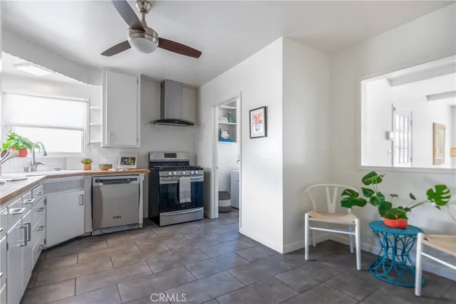 a kitchen with a stove a sink and a refrigerator