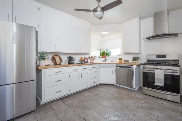 a kitchen with cabinets stainless steel appliances and a window