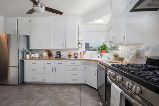 a kitchen with cabinets appliances and a counter