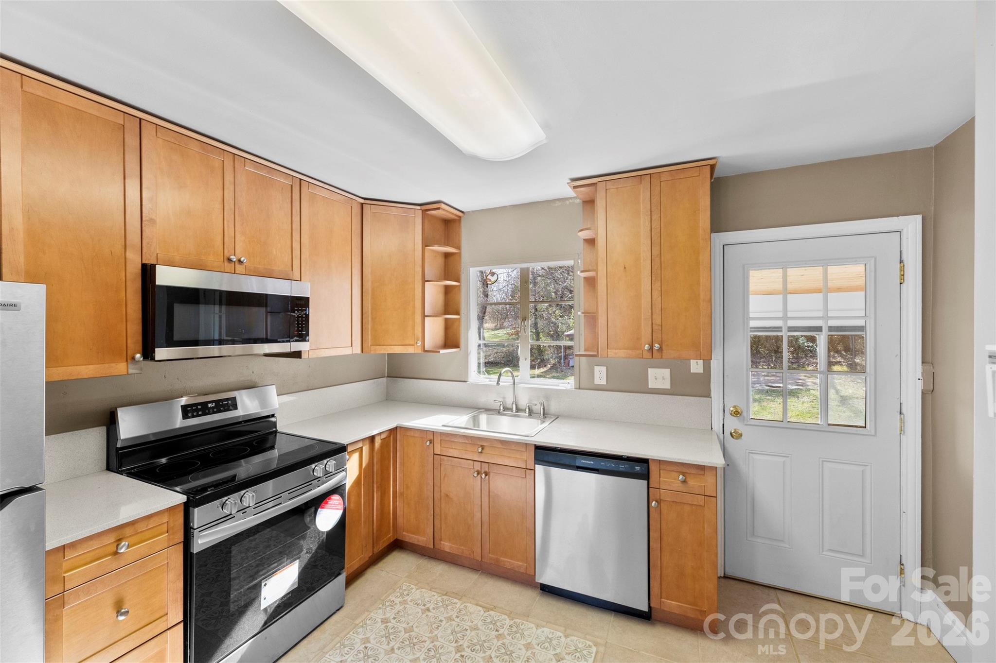 845 St Marks Church Road Cherryville, NC 28021 - Photo 15 of 47 a kitchen with stainless steel appliances granite countertop a stove a sink and a microwave