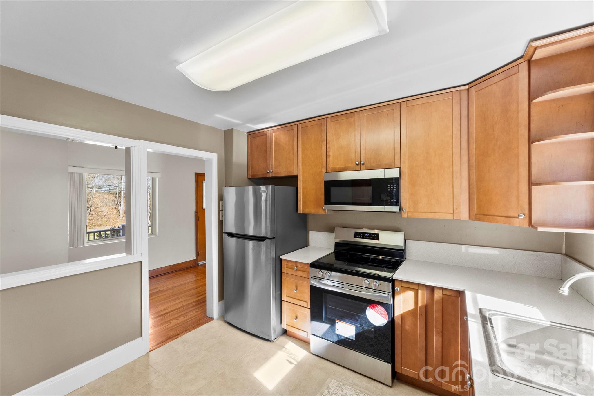 845 St Marks Church Road Cherryville, NC 28021 - Photo 17 of 47 a kitchen with a refrigerator a stove and a sink with wooden floor