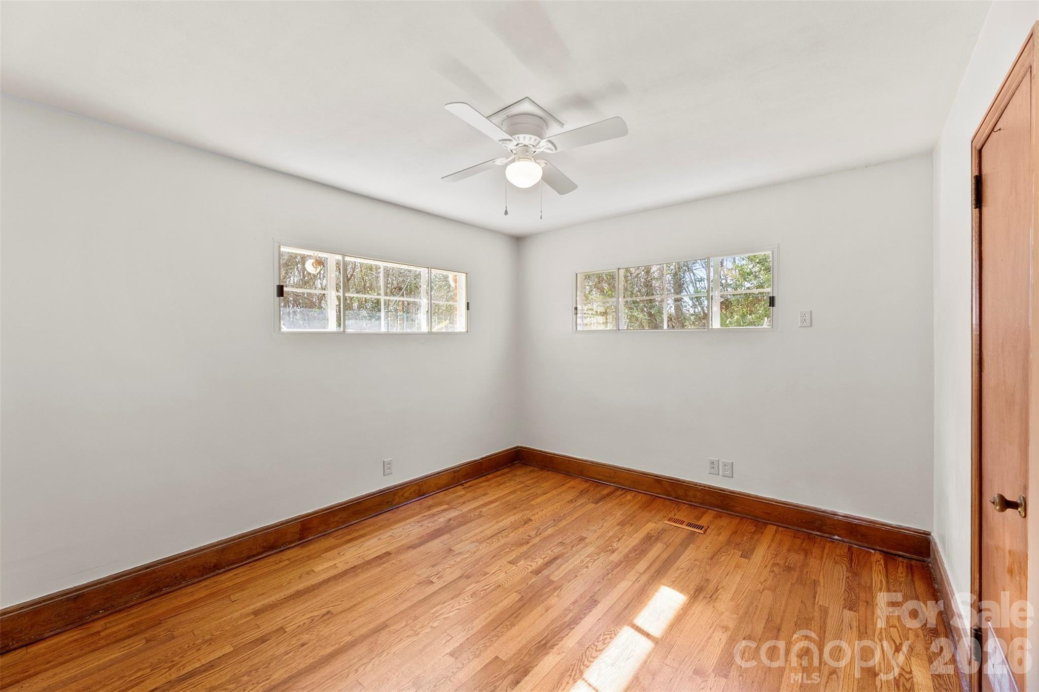 845 St Marks Church Road Cherryville, NC 28021 - Photo 28 of 47 a view of empty room with wooden floor and fan