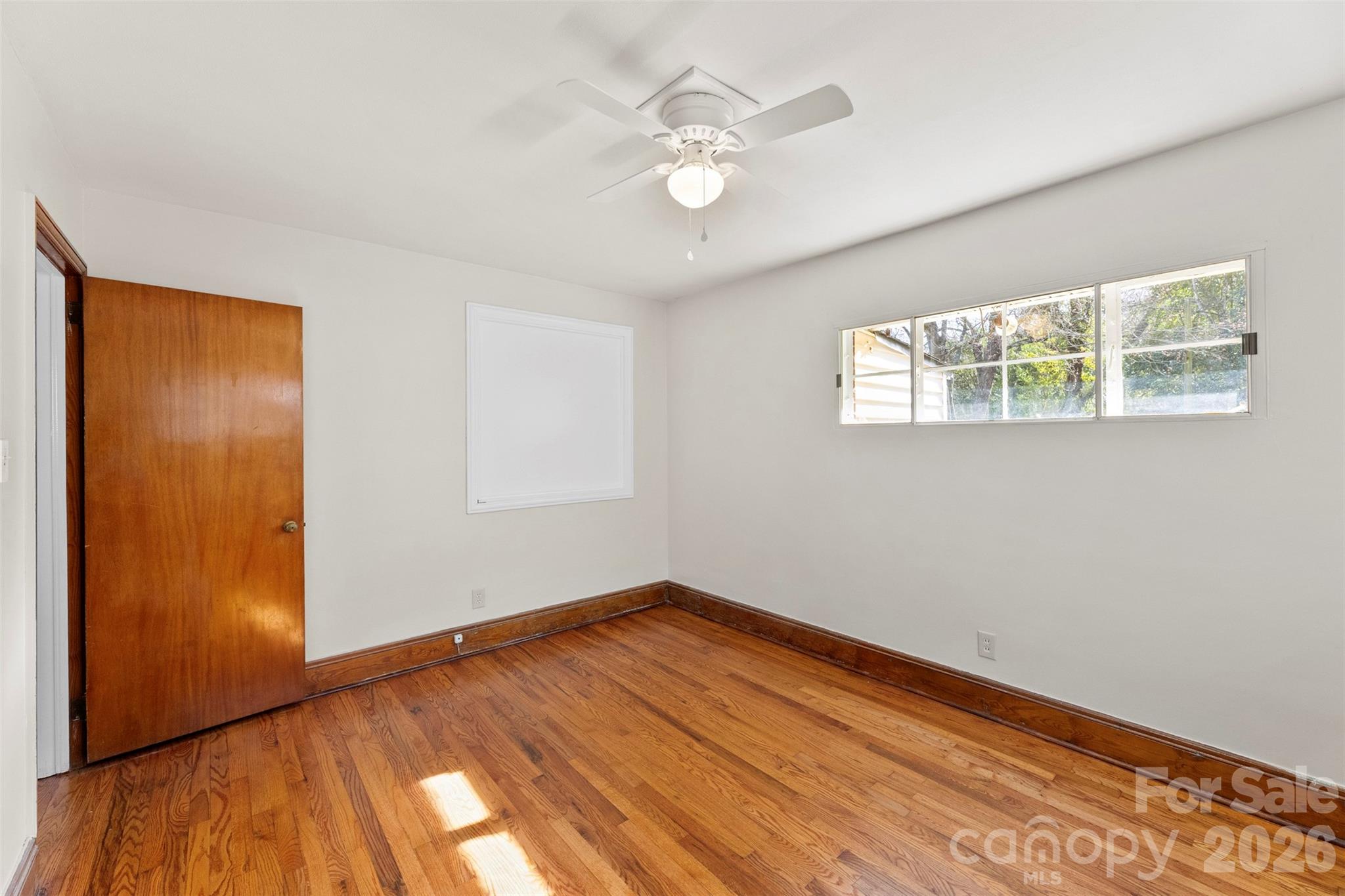 845 St Marks Church Road Cherryville, NC 28021 - Photo 32 of 47 a view of empty room with wooden floor and fan