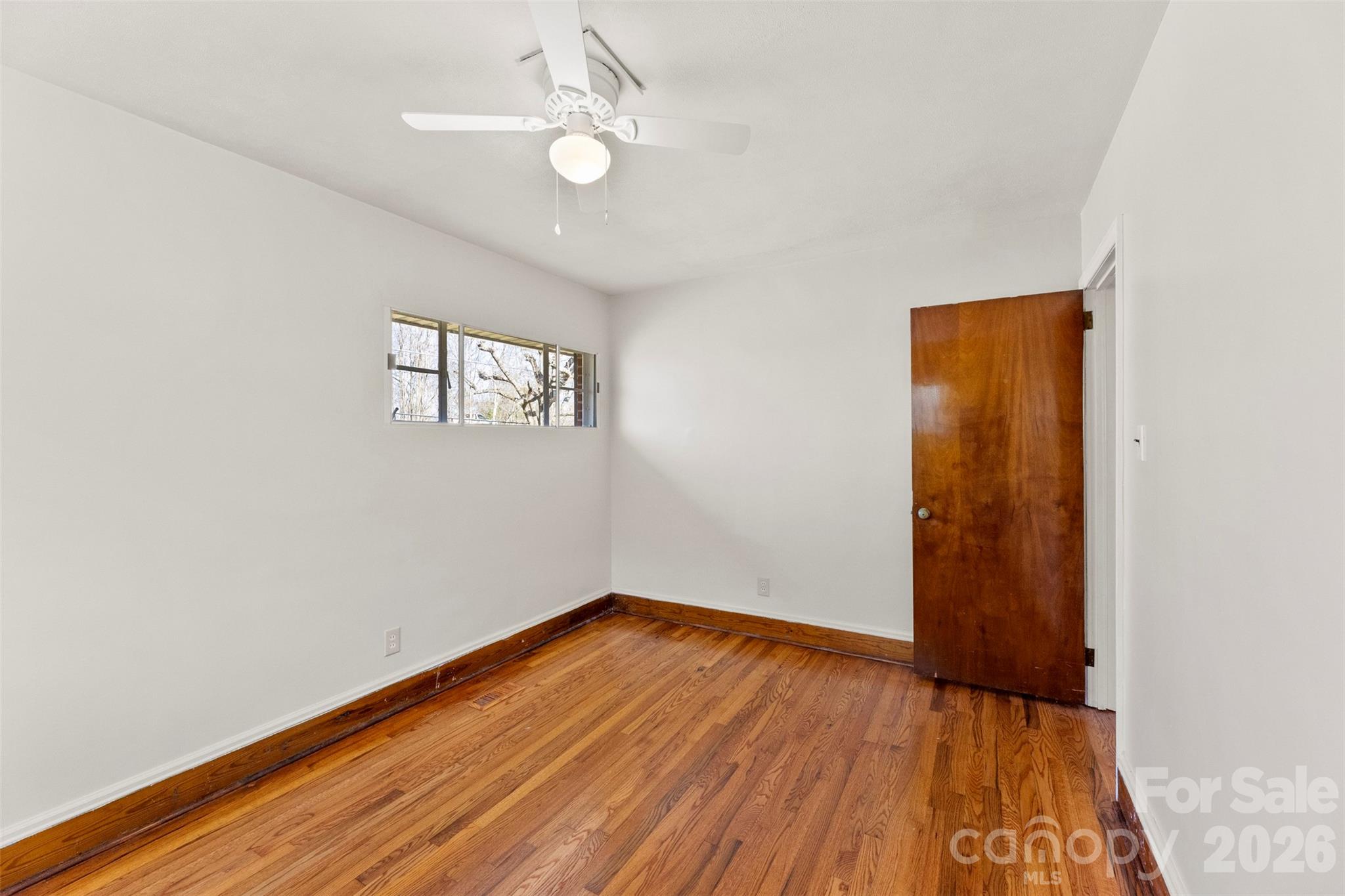 845 St Marks Church Road Cherryville, NC 28021 - Photo 37 of 47 an empty room with wooden floor fan and windows