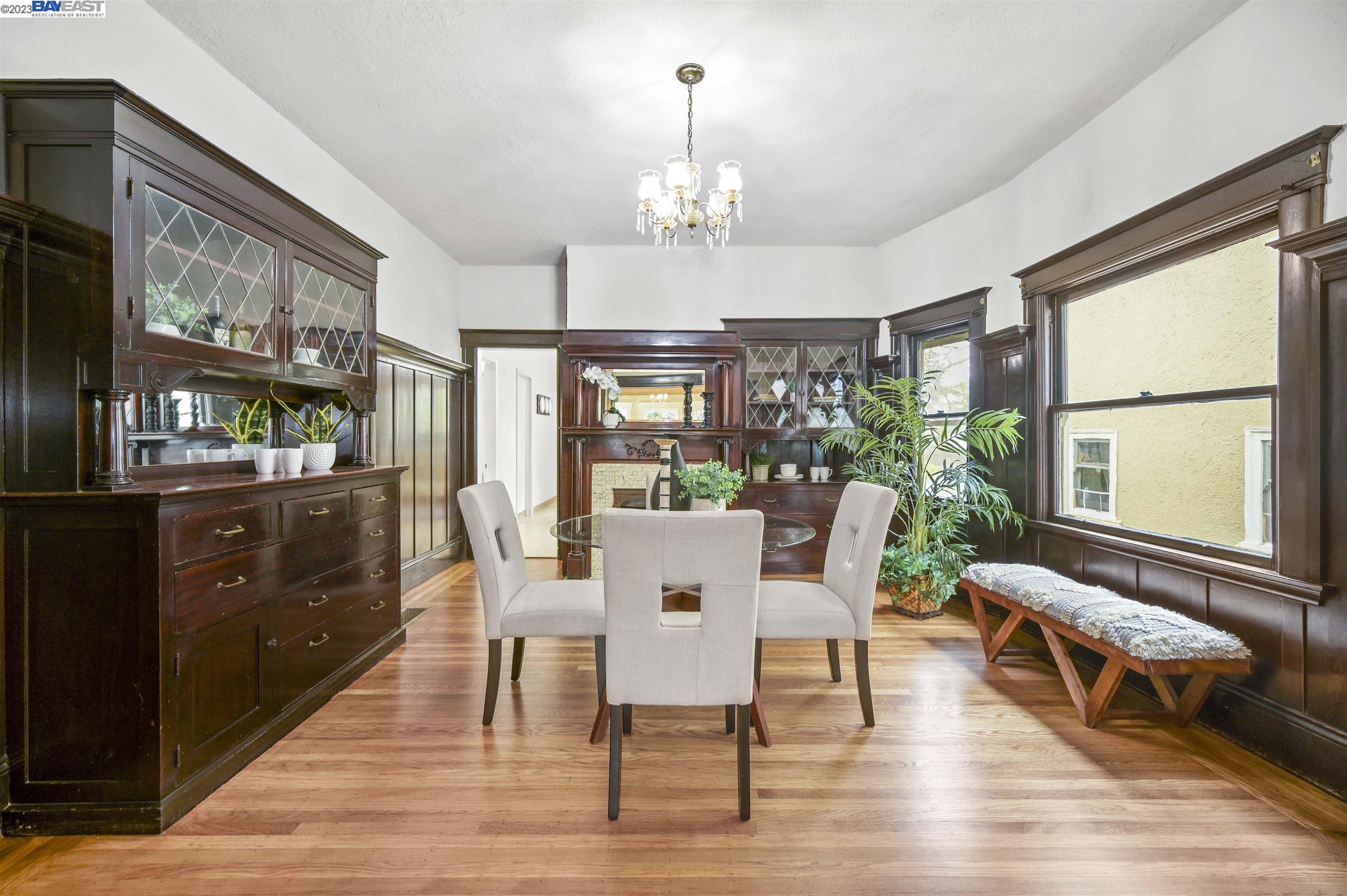 a view of a dining room with furniture a chandelier and wooden floor