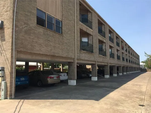 a view of building with car parked